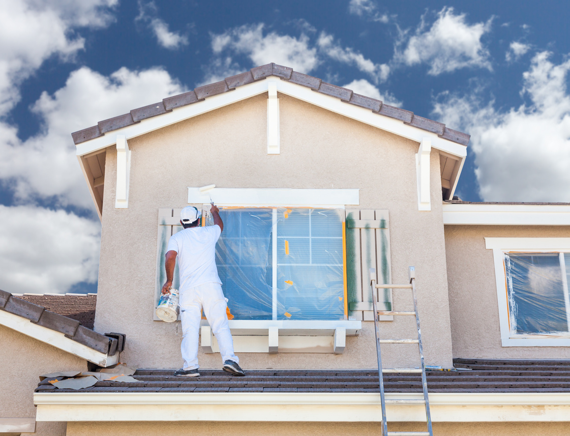 Professional House Painter Painting The Trim And Shutters 